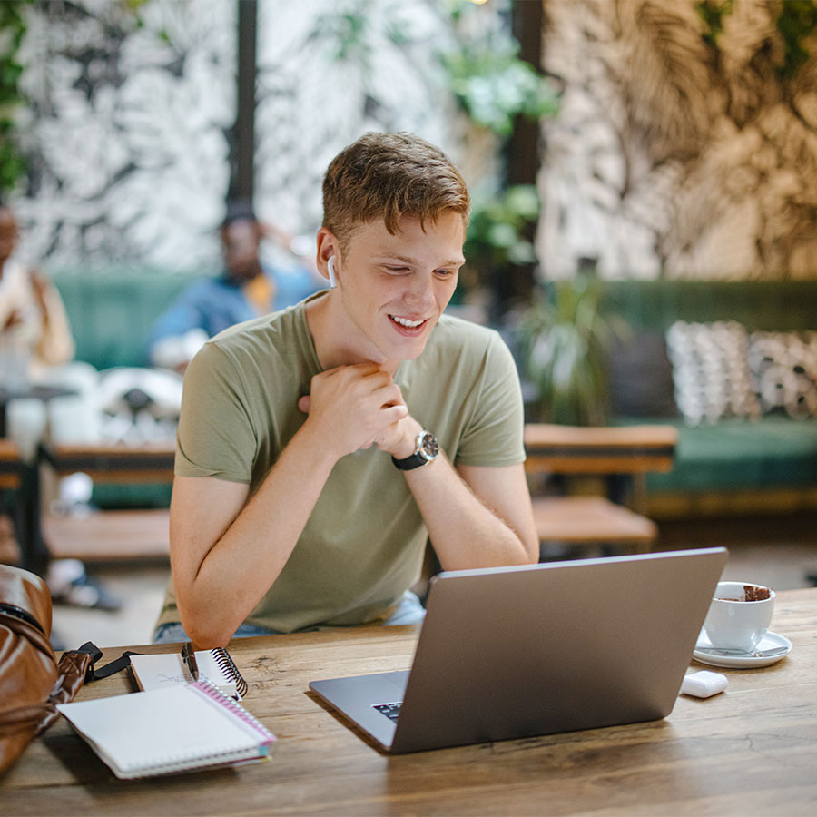 Student looking at laptop, while on a call