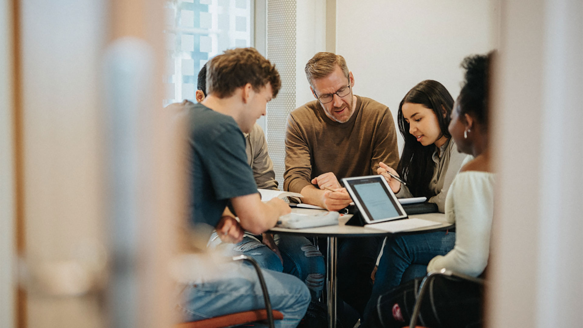Professor and students working together.
